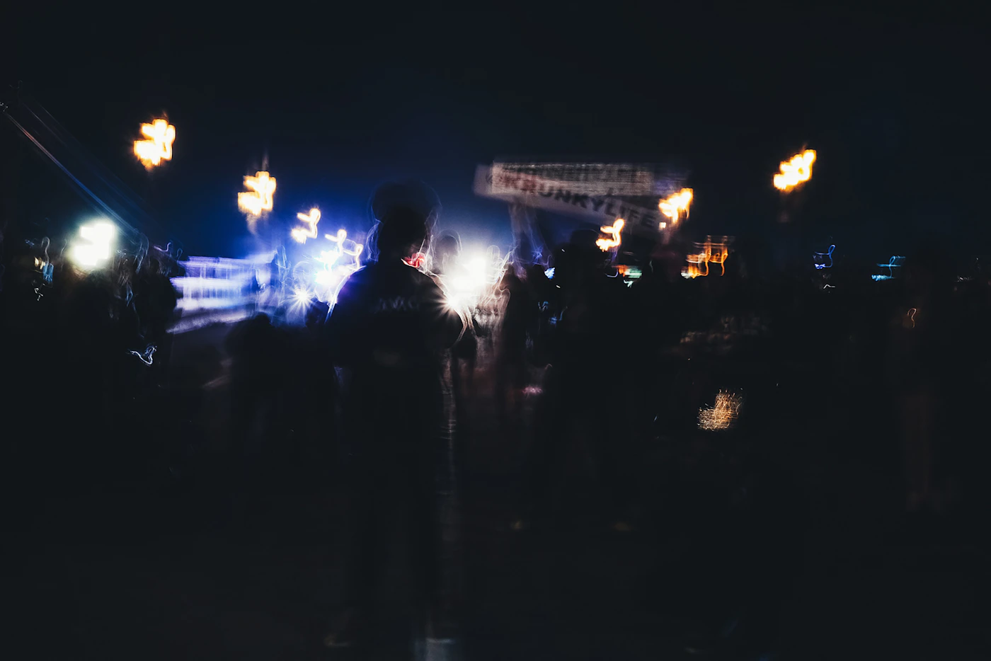 Concert lights and audience silhouettes photographed in motion
